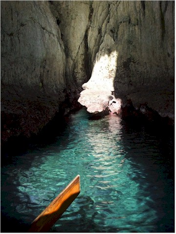 Exploring Swallow's cave - light streams through a hole in the roof.
