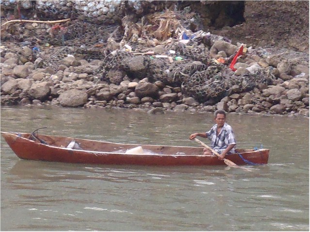 One of the local men in a typical fishing canoe.