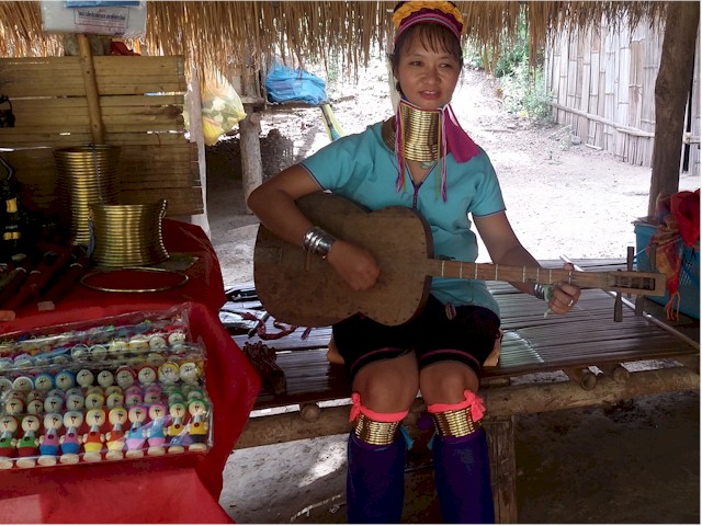 This teenage girl has several rings on her neck as well as on the arms and legs.
