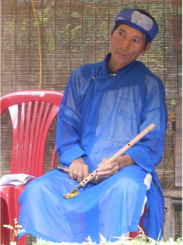 
We caught the end of a water puppet demonstration, and this was one of the musicians.
