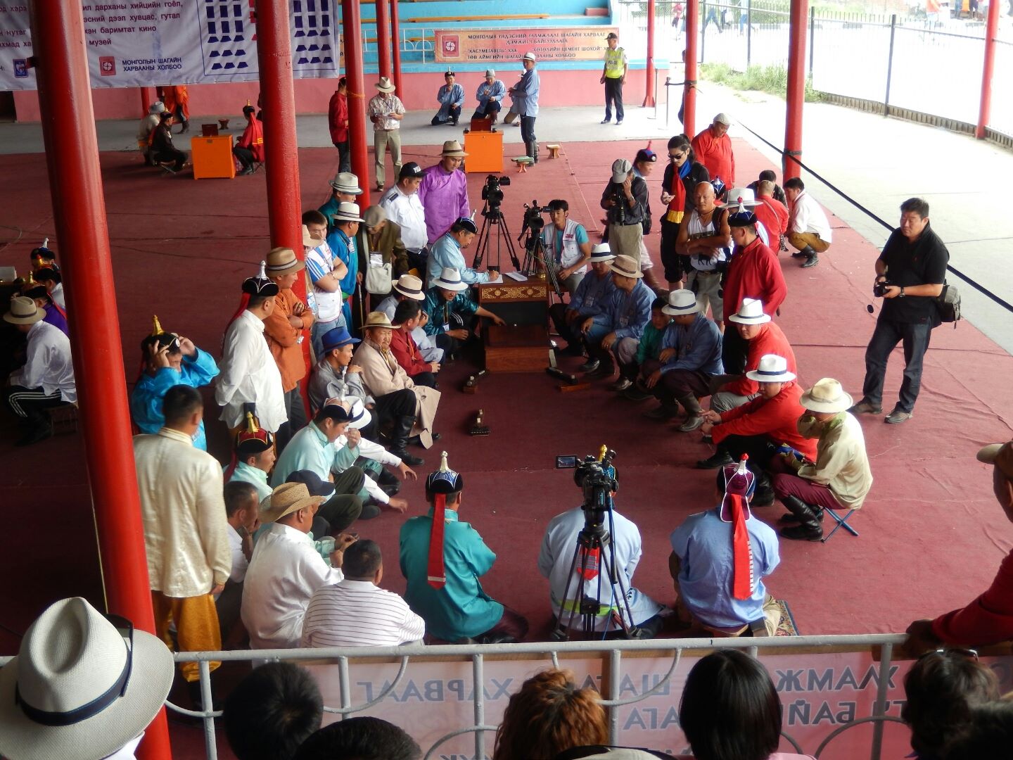 
An exciting game being watched by both the teams - and a crowd of spectators.
